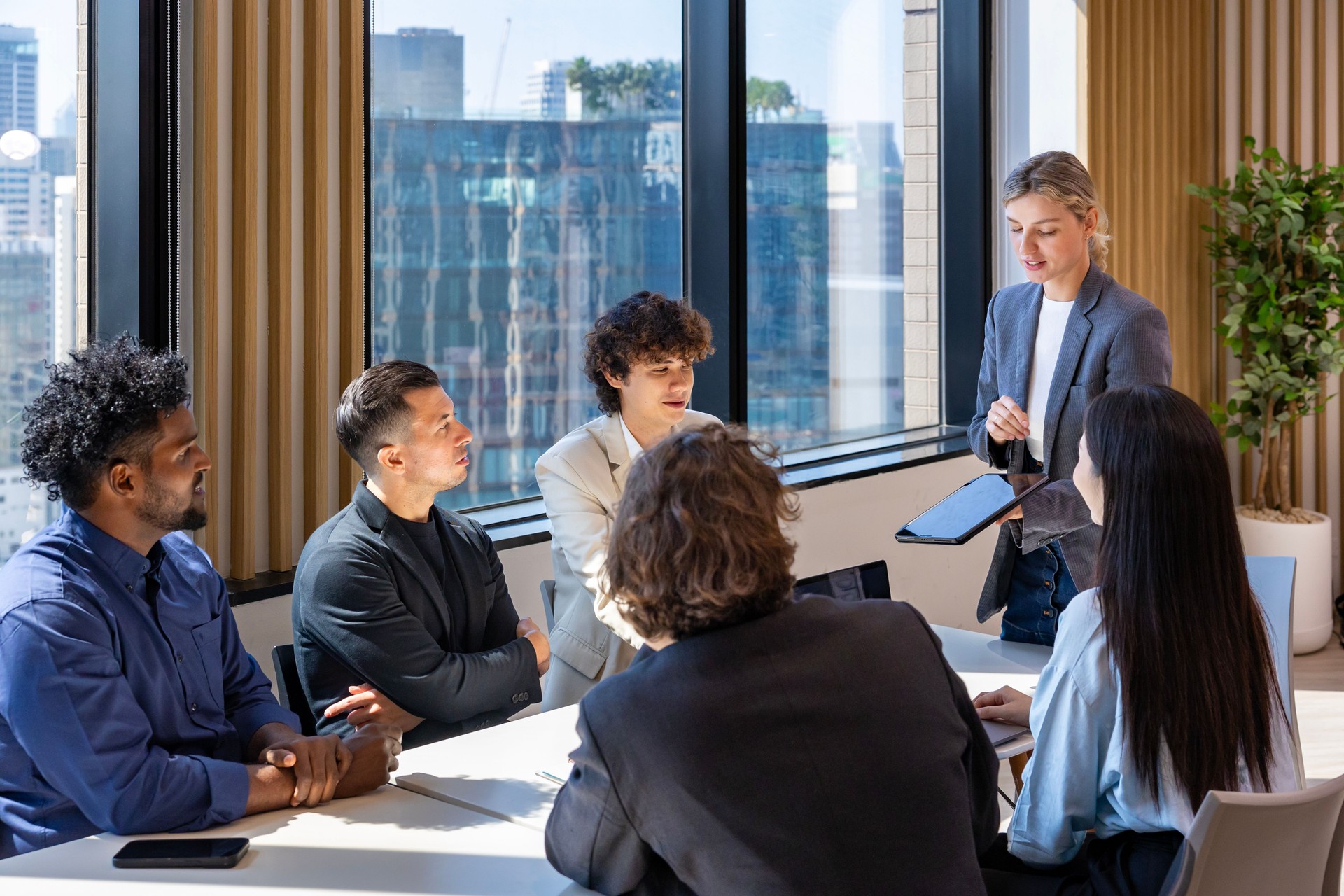 Caucasian woman sale manager is showing annual report chart to colleagues in executive meeting for next year plan with market share increase for global business and investment