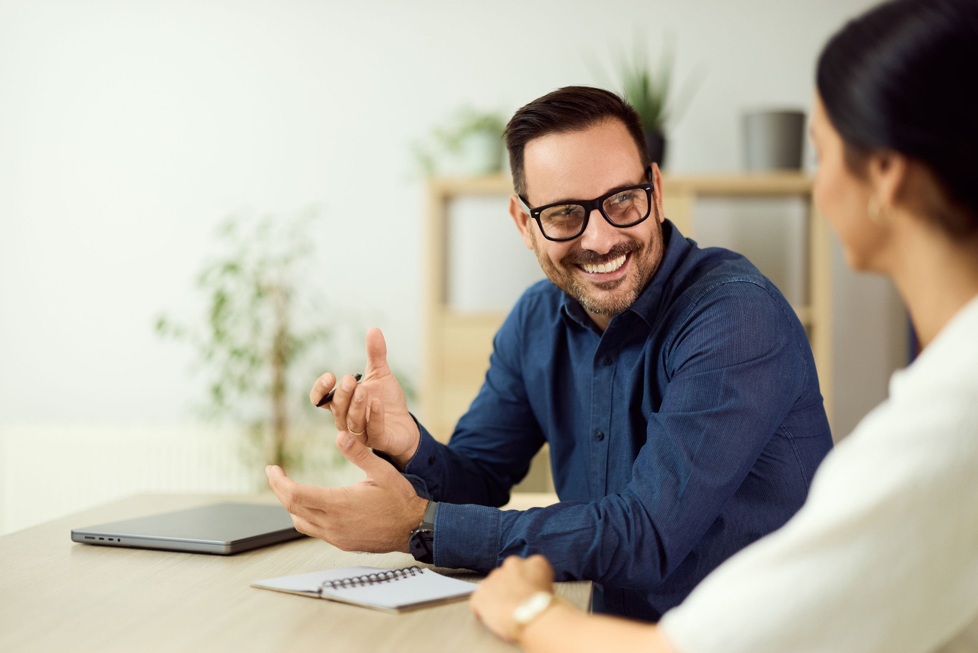 Smiling Professionals Interacting During a Friendly Business Meeting in an Office Setting